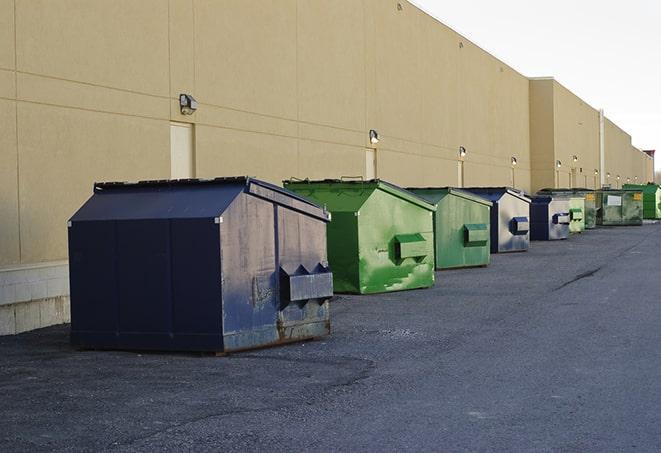 dumpsters lined up for use on busy construction site in Baxter